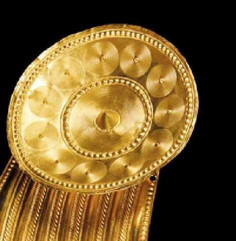 Detail of Gorget. This is a close up view of one of the Terminal Discs. You can see in the very centre there is a large cone shaped Boss. Decorating the surface of the Terminal Disc are rings of raised dots made using the Repoussé technique and also rings of concentric circles which have been incised into the surface.